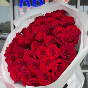 50 long-stem premium roses in a white floral wrap